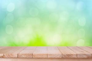 brown wood table top on bokeh abstract green background - can be used for montage or display your products photo