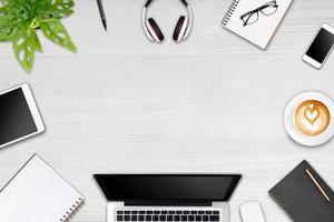 Modern workspace with laptop tablet, smartphone and coffee cup copy space on color background. Top view. Flat lay style. photo