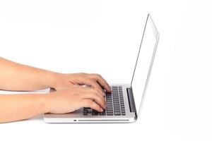 Hands typing on keyboard of laptop on white background photo