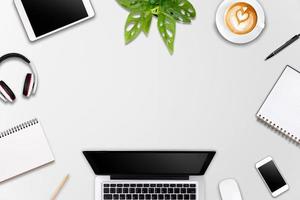 Modern workspace with laptop tablet, smartphone and coffee cup copy space on color background. Top view. Flat lay style. photo