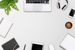 Modern workspace with laptop tablet, smartphone and coffee cup copy space on color background. Top view. Flat lay style. photo