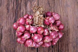 red onions on wood background photo