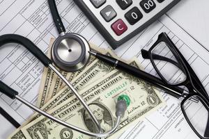 Health care costs. Stethoscope and money symbol for health care costs or medical insurance photo