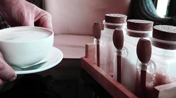 entreprise de café et de boulangerie, concept de personnes et de service, homme ou serveur sert une tasse de café blanc chaud dans un café - gros plan à portée de main et contenant de sucre posé sur une table video