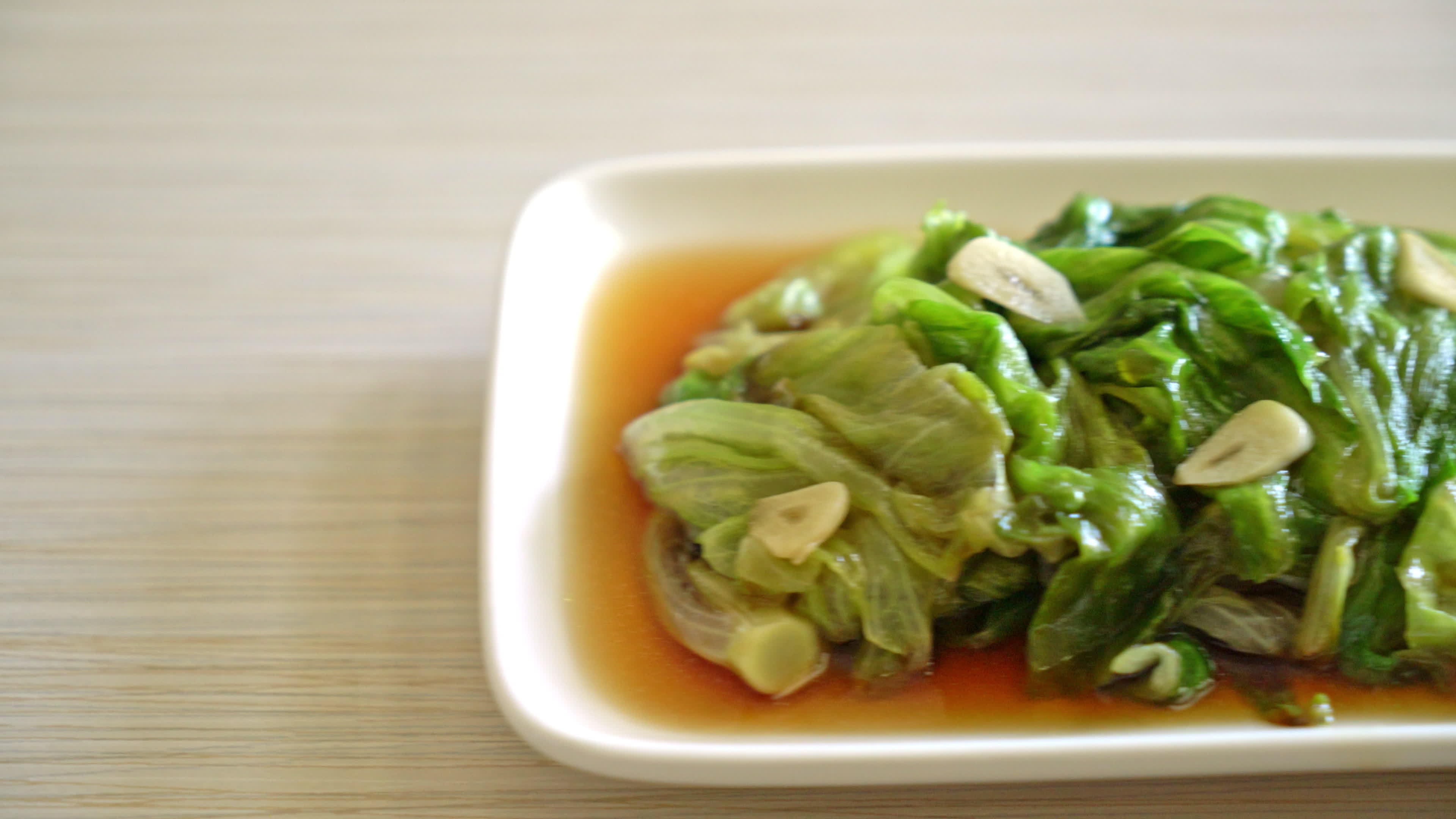 Stir fried Iceberg lettuce with Oyster sauce Healthy food style 9807742 Stock Video at Vecteezy