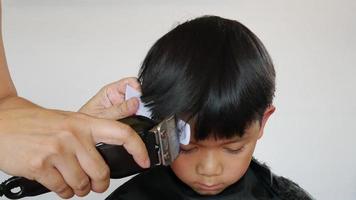 A boy is cut his hair by hair dresser video