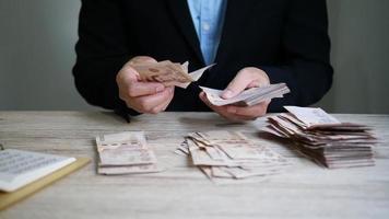 Man counting bank note Thai Baht money, slow motion footage video