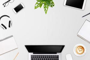 Modern workspace with laptop tablet, smartphone and coffee cup copy space on color background. Top view. Flat lay style. photo