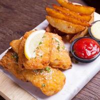 pescado y patatas fritas con cuña de patata foto