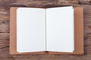 Blank empty notepad on wood background photo