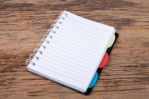 Blank empty notepad on wood background photo