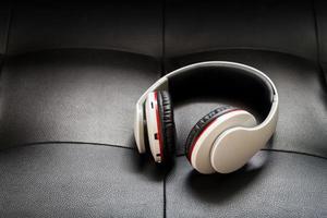 Bluetooth headphones on black leather background photo