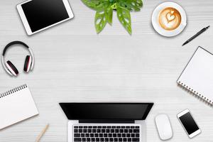 Modern workspace with laptop tablet, smartphone and coffee cup copy space on color background. Top view. Flat lay style. photo