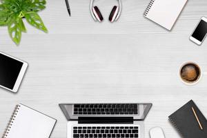 Modern workspace with laptop tablet, smartphone and coffee cup copy space on color background. Top view. Flat lay style. photo