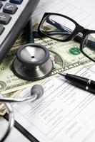 stethoscope and dollar on blank Patient information photo