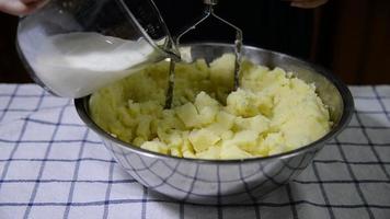 People making homemade mashed potato - food preparation in kitchen concept video