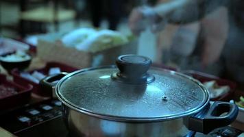 People eating suki yaki in hot pot deliciously - Asian Japanese food meal concept video