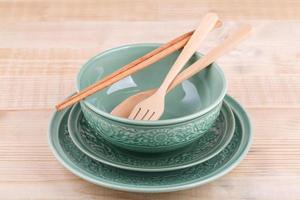 Empty caramic celadon dish with bowl and spoon fork photo