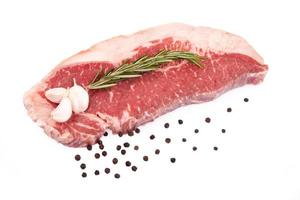 Raw red sirloin steak with rosemary, garlic , pepper photo