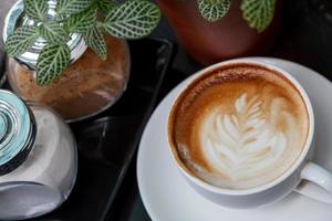 Close-up cup of latte coffee on wooden photo