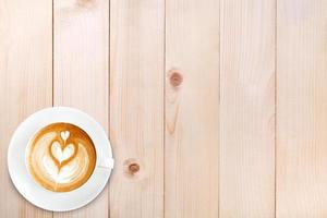 Top view latte art coffee on wood background photo