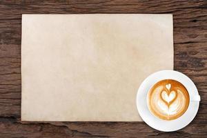 blank paper with pencil and a cup of coffee on wooden photo