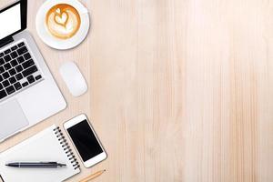 Top view laptop computer or notebook,mobile phone and cup of latte art coffee on wooden tablemobile phone,and cup of latte art coffee on wooden table photo