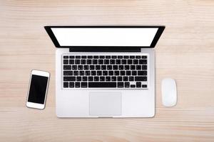 Top view laptop computer with mobile phone on wood table.Business template mock up for adding your text. photo