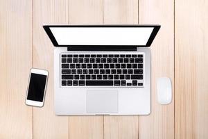 Top view laptop computer with mobile phone on wood table.Business template mock up for adding your text. photo