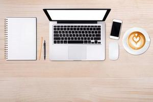 Top view laptop computer or notebook,mobile phone and cup of latte art coffee on wooden table. Business template mock up for adding your text. photo