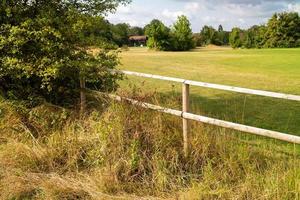 golf course with grass and clouds in the sky photo