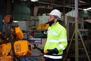 Industrial Engineers in Hard Hats.Work at the Heavy Industry Manufacturing Factory. industrial worker indoors in factory. man working in an industrial photo