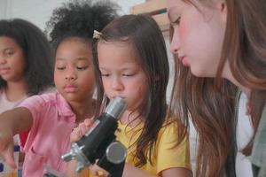 Student in classroom, young girl happy funny study and play with experimenting in class. photo