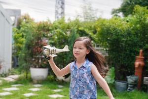 Child Play With Airplane outdoor - Imagination And Freedom Concept photo