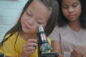 Student in classroom, young girl happy funny study and play with experimenting in class. photo