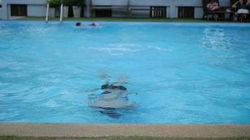 Fifteen years boy is happily swimming in water pool video