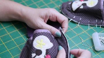 Lady making work handmade cloth shoe - closeup housework DIY concept video