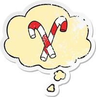 cartoon candy canes and thought bubble as a distressed worn sticker vector