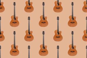 Seamless pattern of wood texture of lower deck of six strings acoustic guitar on orange background photo