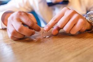 hands of the groom with ring. thoughts of marriage photo