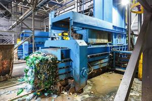 Plastic bales at the waste processing plant. Separate garbage collection. Recycling and storage of waste for further disposal. Business for sorting and processing of waste. photo