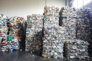 Plastic bales at the waste processing plant. Separate garbage collection. Recycling and storage of waste for further disposal. Business for sorting and processing of waste. photo