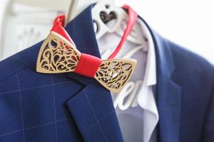 Wooden bow tie on blue jacket photo