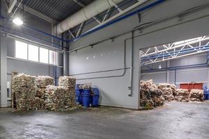 Plastic bales at the waste processing plant. Separate garbage collection. Recycling and storage of waste for further disposal. Business for sorting and processing of waste. photo