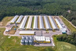 aerial view on silos and agro-industrial livestock complex on agro-processing and manufacturing plant with modern granary elevator. chicken farm. rows of chicken coop photo