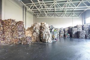 Plastic pressed bales at the modern waste hazardous processing plant. Separate garbage collection. Recycling and storage of waste for further disposal. Business for sorting and processing of waste. photo