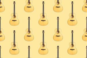 Seamless pattern of wood texture of lower deck of six strings acoustic guitar on yellow background photo