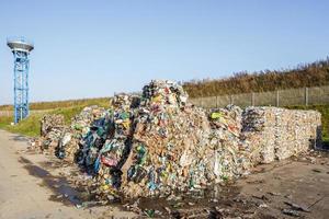 Plastic bales at the waste processing plant. Separate garbage collection. Recycling and storage of waste for further disposal. Business for sorting and processing of waste. photo