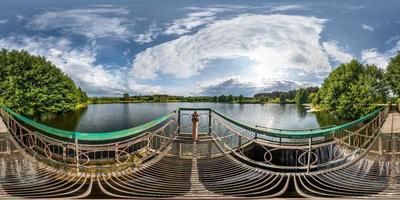 full seamless spherical hdri panorama 360 degrees angle view near the metal dam with waterfall of wide lake in sunny day in equirectangular projection, ready VR AR virtual reality content photo