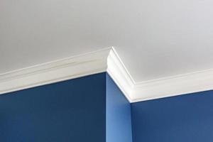 Detail of corner ceiling with intricate crown molding. photo